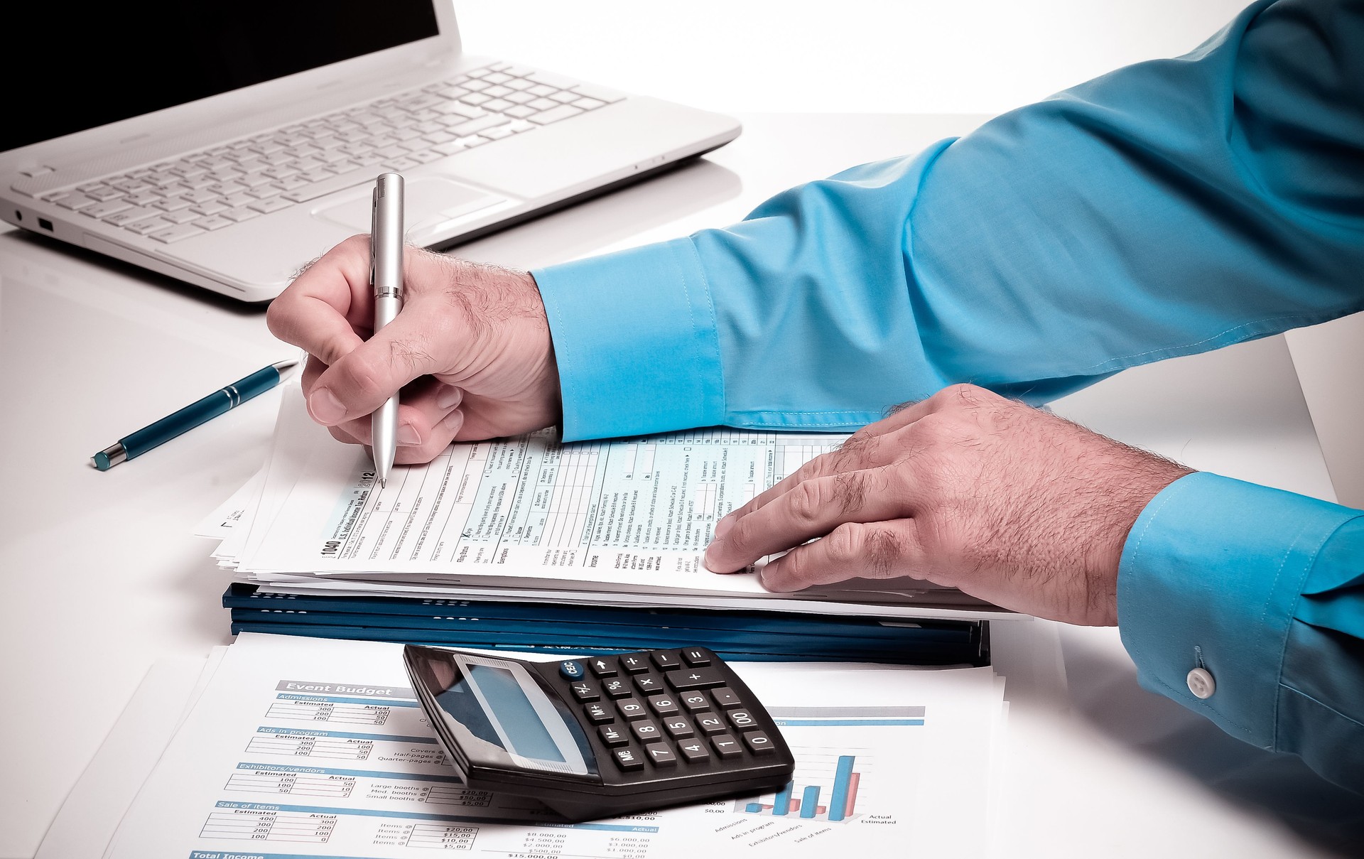 Young professional caucasian businessman with taxes and finances in office